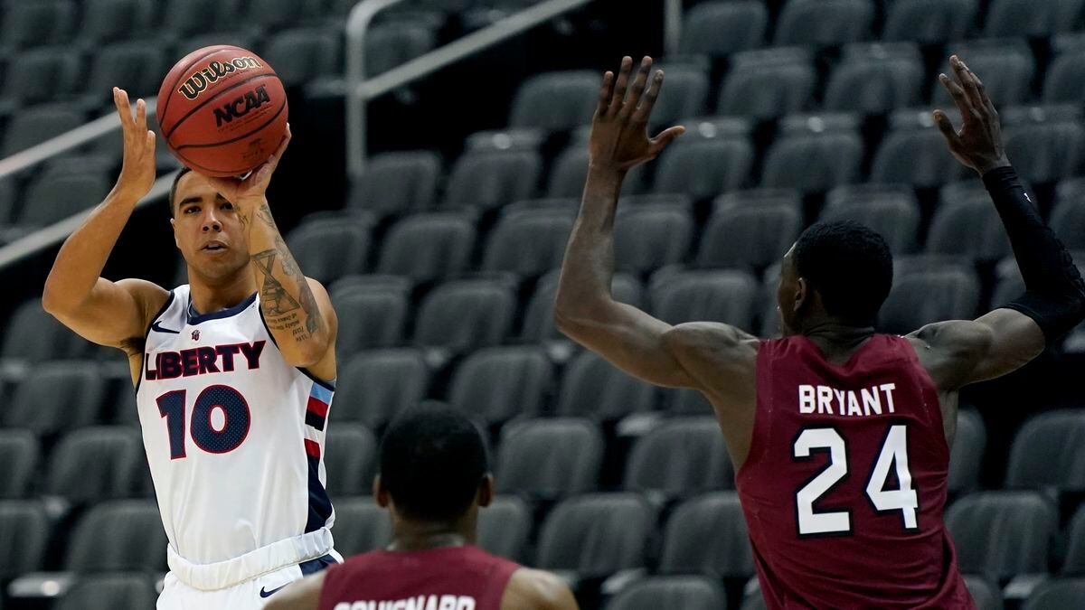 Liberty's Elijah Cuffee (10) shoots over South Carolina's Jermaine Couisnard (5) and Keyshawn...