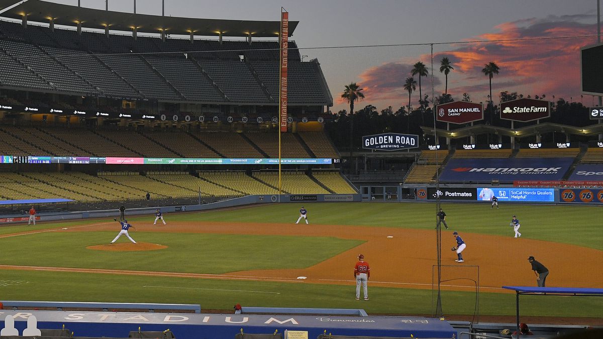 The Los Angeles Dodgers play the Los Angeles Angels at sunset during the fifth inning of a preseason baseball game, Tuesday, July 21, 2020, in Los Angeles.