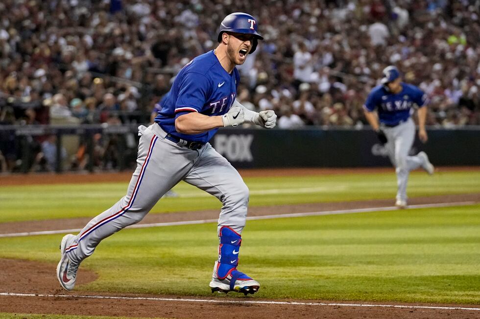 Texas Rangers' Mitch Garver celebrates after a RBI single against the Arizona Diamondbacks...
