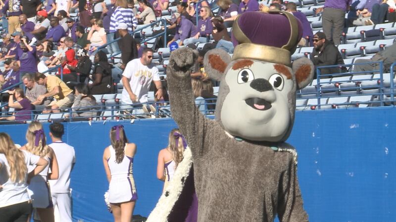 Duke Dog, the James Madison mascot, holds his fist in the air after a JMU touchdown against...