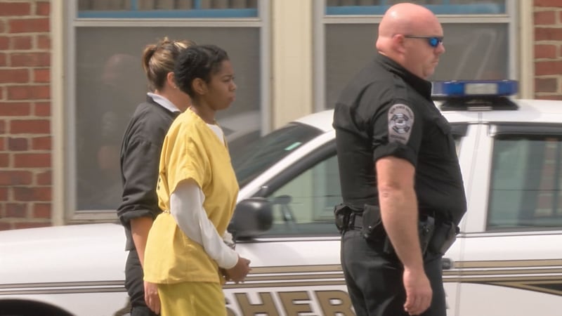 Kia Kitchen is escorted out of the Pulaski County Courthouse on Thursday, July 7, 2016.