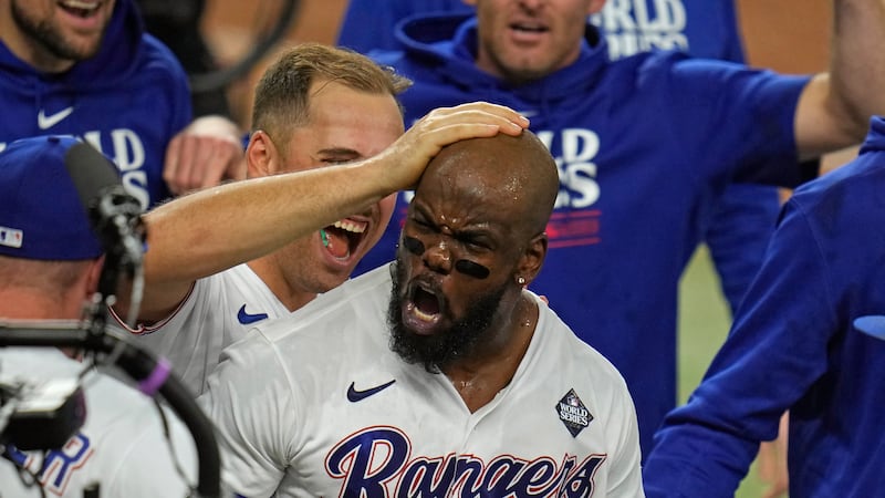 Texas Rangers' Adolis Garcia celebrates with teammates after hitting a game-winning home run...