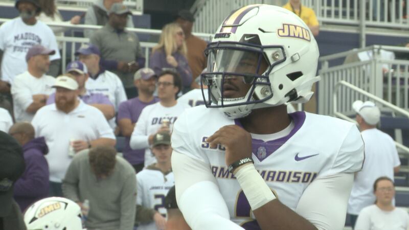 James Madison quarterback Jordan McCloud warms up before taking the field against Georgia...