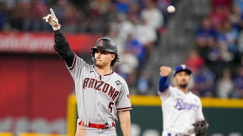 Arizona Diamondbacks' Alek Thomas celebrates after a double against the Texas Rangers during...