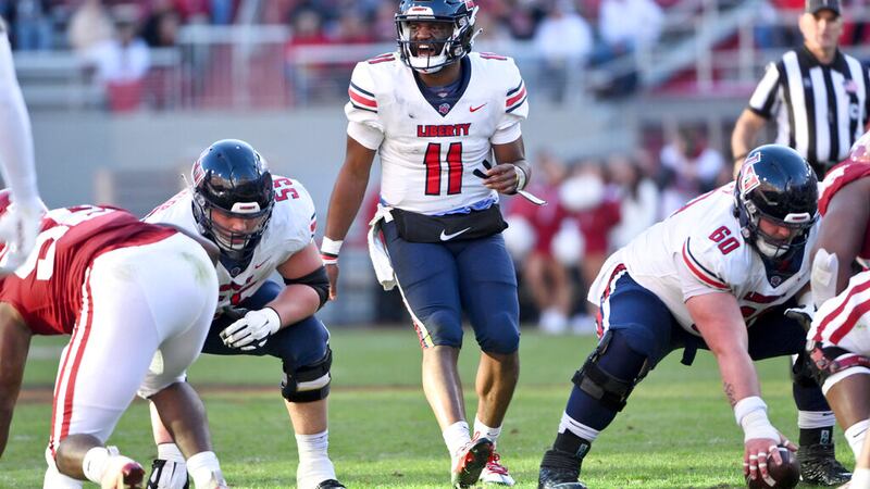 Liberty quarterback Johnathan Bennett (11) gets ready to run a play against Arkansas during an...