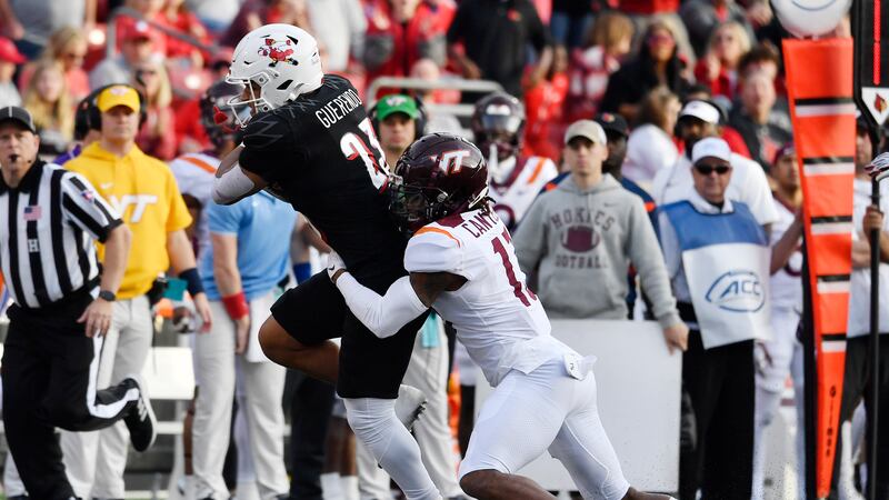 Virginia Tech cornerback Derrick Canteen (13) tries to bring down Louisville running back...